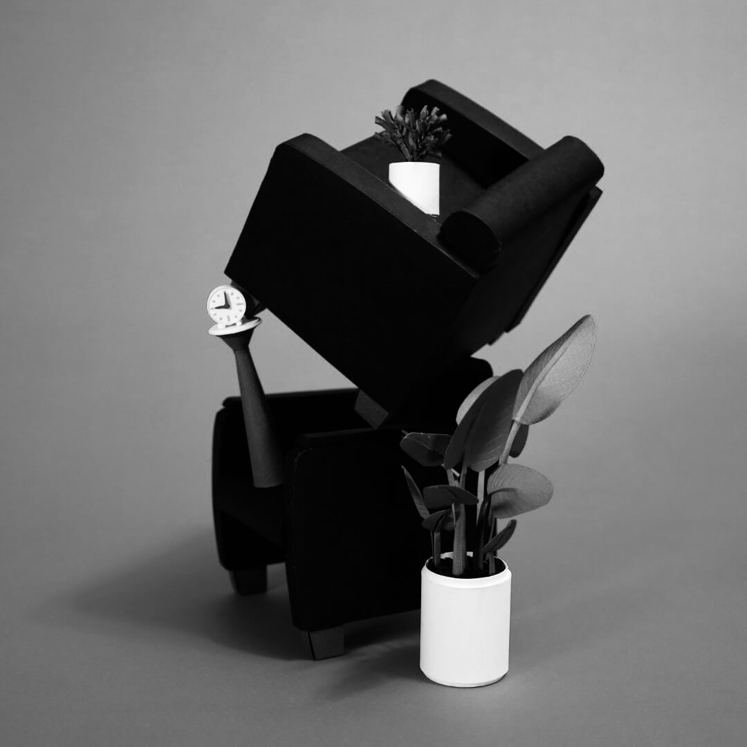 Miniature scene with a tilted chair and plants