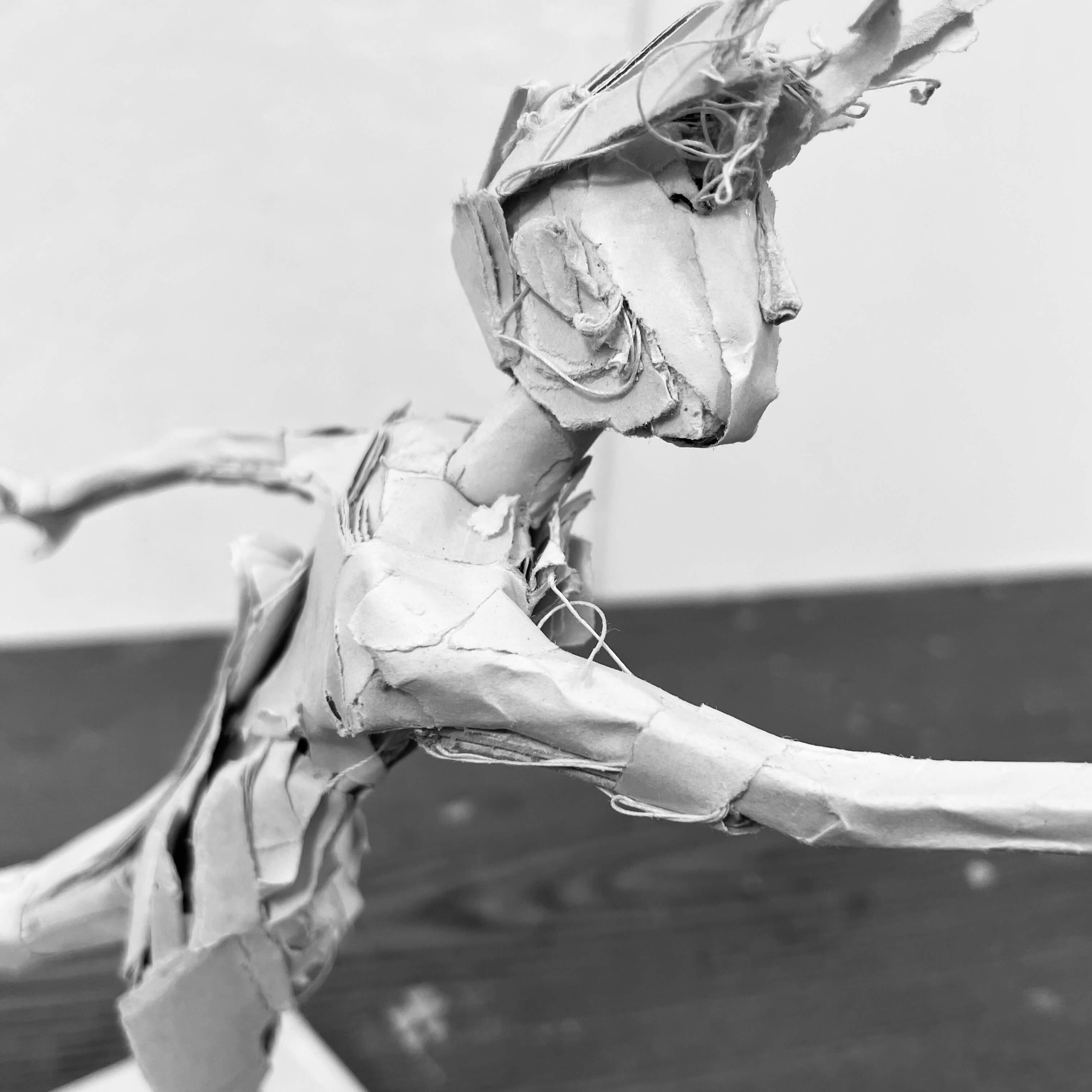 Paper sculpture of a running figure
