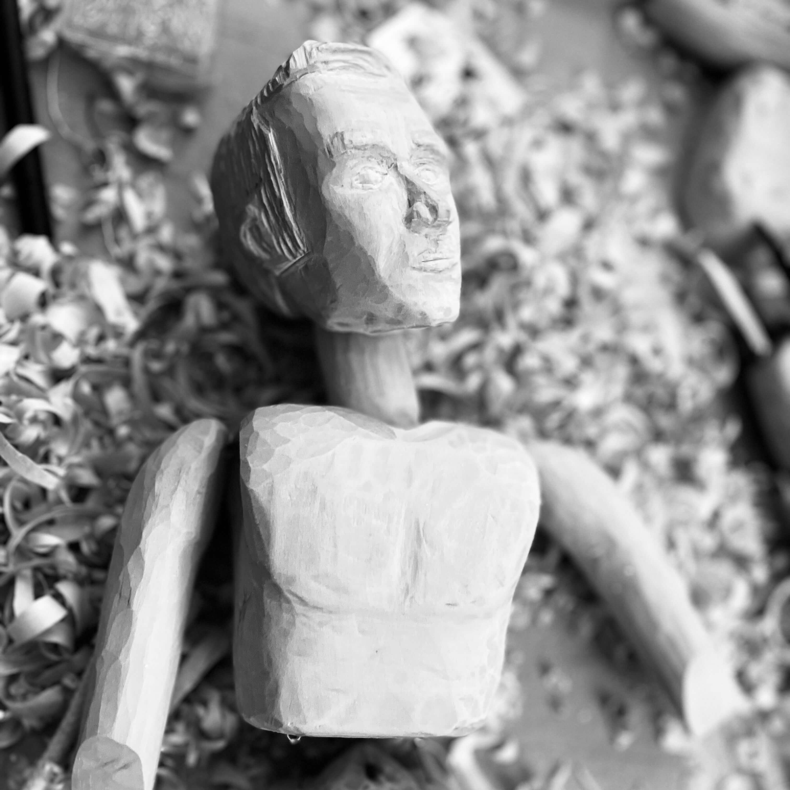 Woodcarving of a human figure in progress